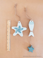 Coastal-themed wooden starfish and fish decor set, perfect for beach-inspired decor or nautical crafts.