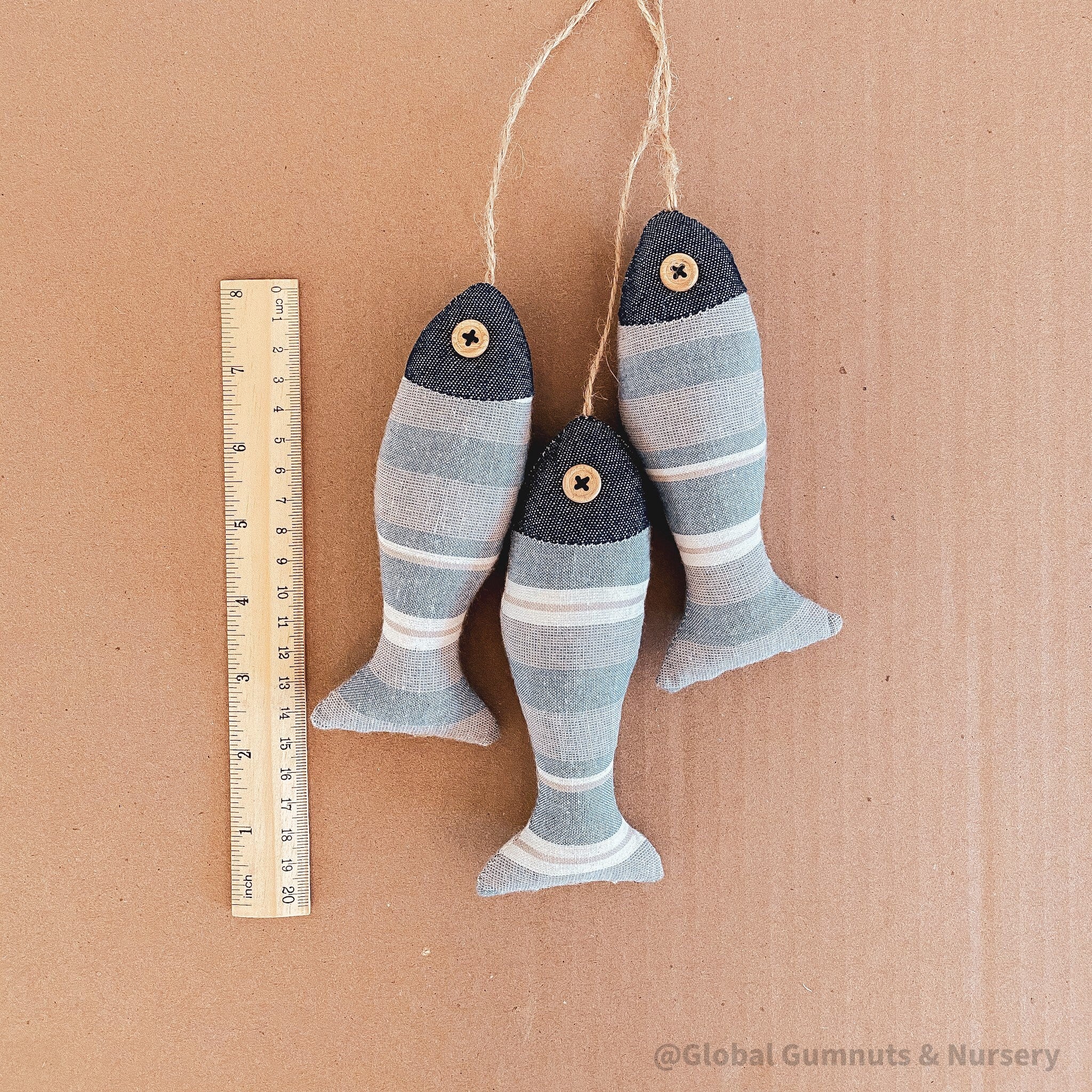 Seaside serenity ocean breeze fabric fish trio, a charming decor set.
