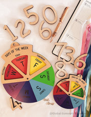Days of the Week Wheel: Educational MDF round wheel with three-way viewer to display the days of the week; features a spinner for easy use.