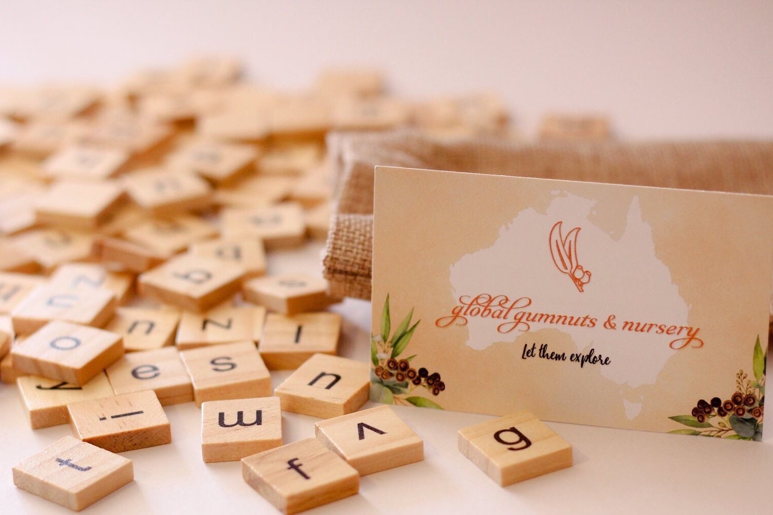 26-piece wooden uppercase letter tiles, ideal for teaching letter recognition, Scrabble, and creative craft projects.
