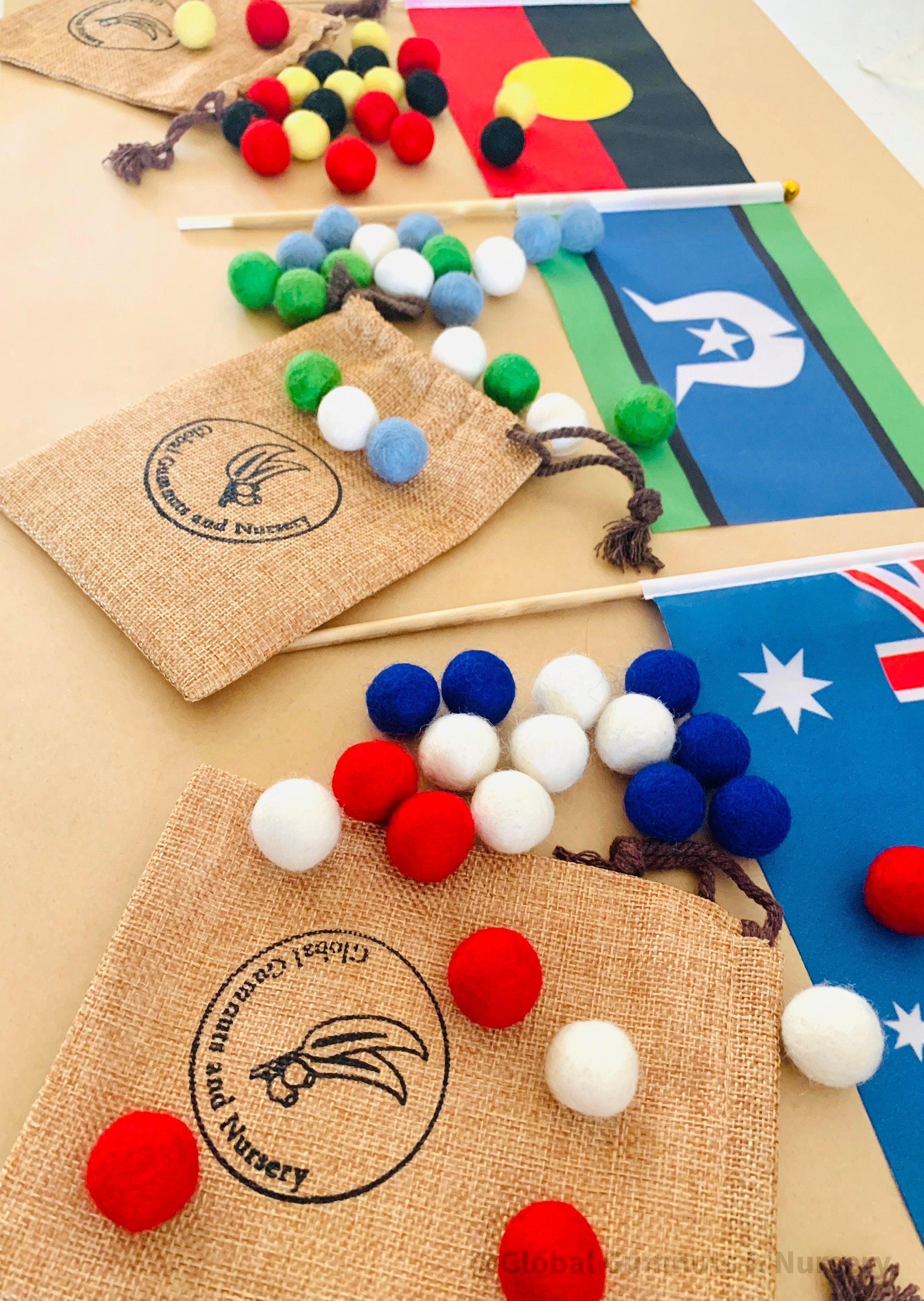 Australian Flag on Wooden Pole: Aboriginal and Australian flag set with optional felt balls.