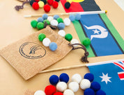 Torres Strait Islander Flag Ornament: Wooden flag on a pole for NAIDOC Week displays.