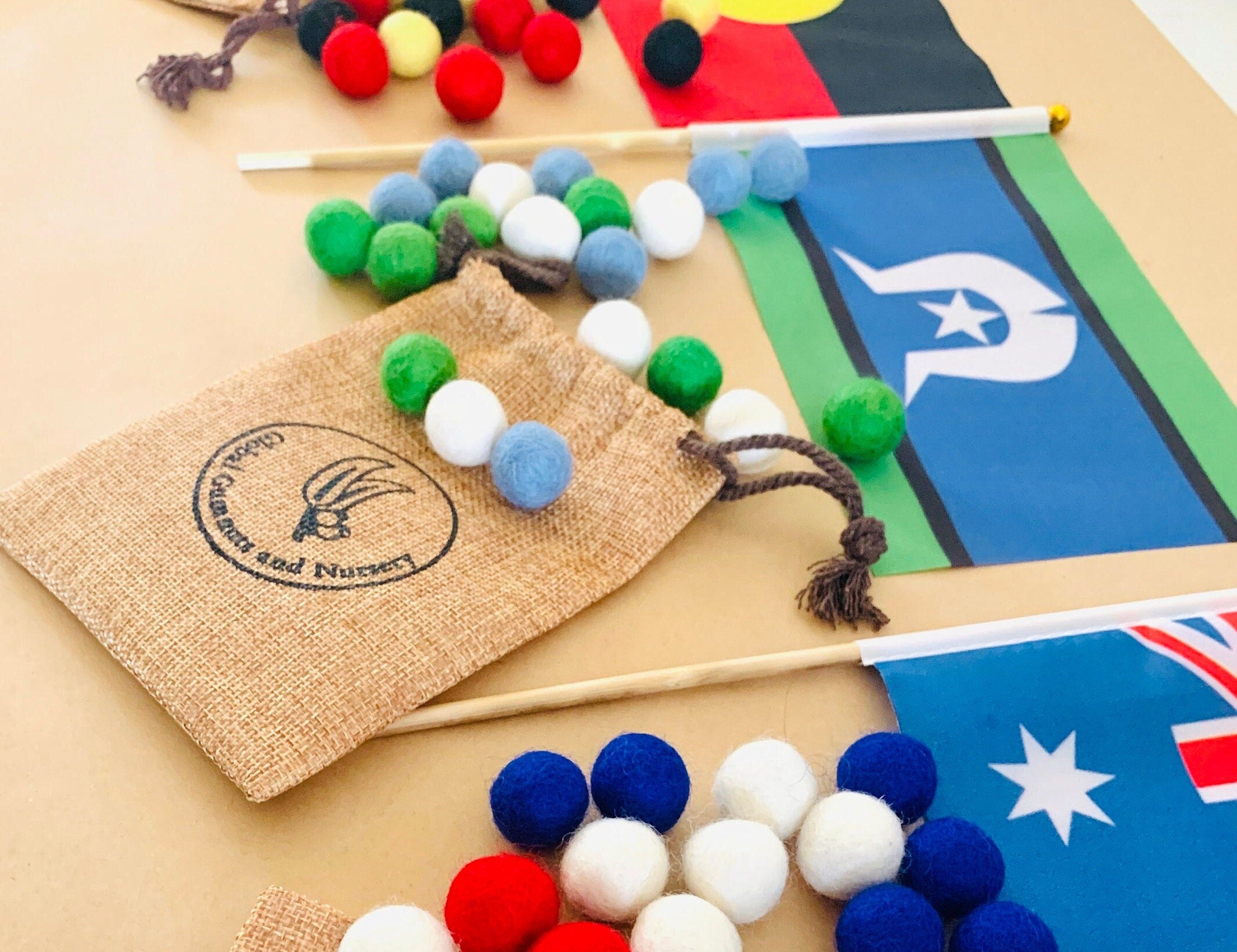 Torres Strait Islander Flag Ornament: Wooden flag on a pole for NAIDOC Week displays.