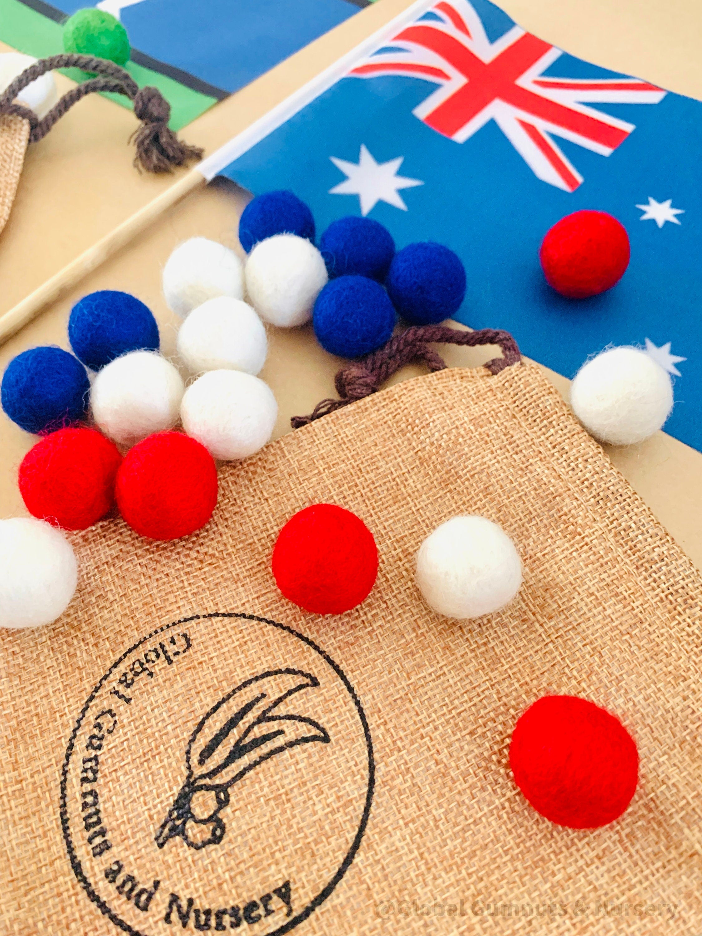 Australian Flag on Wooden Pole: Aboriginal and Australian flag set with optional felt balls.