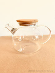 Glass Teapot with Bamboo Lid: Stylish glass teapot with bamboo lid, perfect for tea time or as a display piece for modern decor.