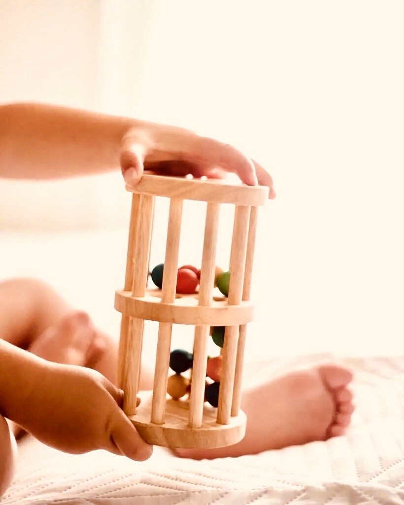 Wooden rainmaker toy in two sizes, a magical sensory and musical toy for kids.