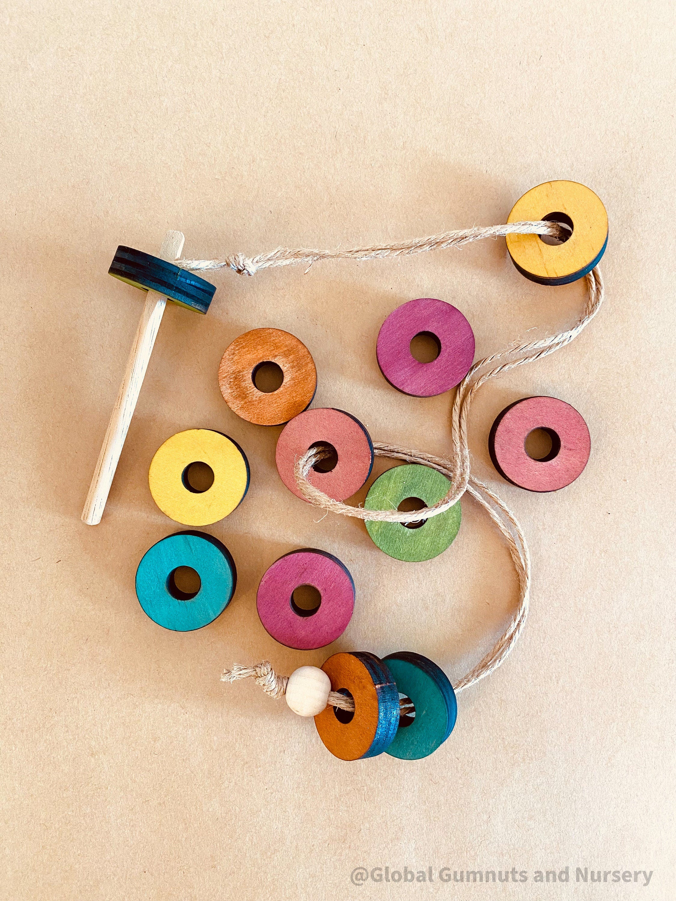 Rainbow Threading Beads: Colourful wooden beads for threading and sensory play, designed to encourage fine motor skills and creativity.