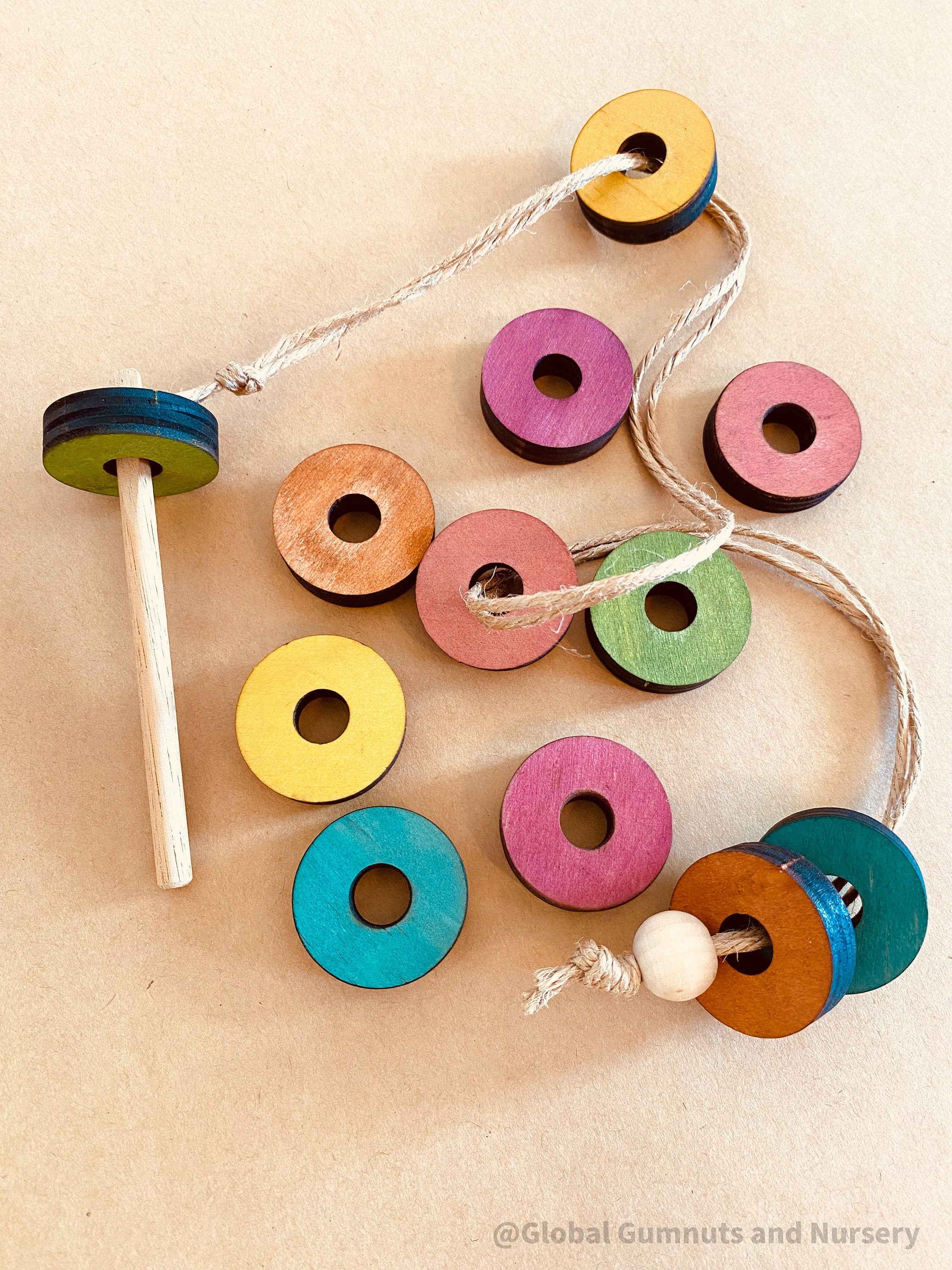 Rainbow Threading Beads: Colourful wooden beads for threading and sensory play, designed to encourage fine motor skills and creativity.