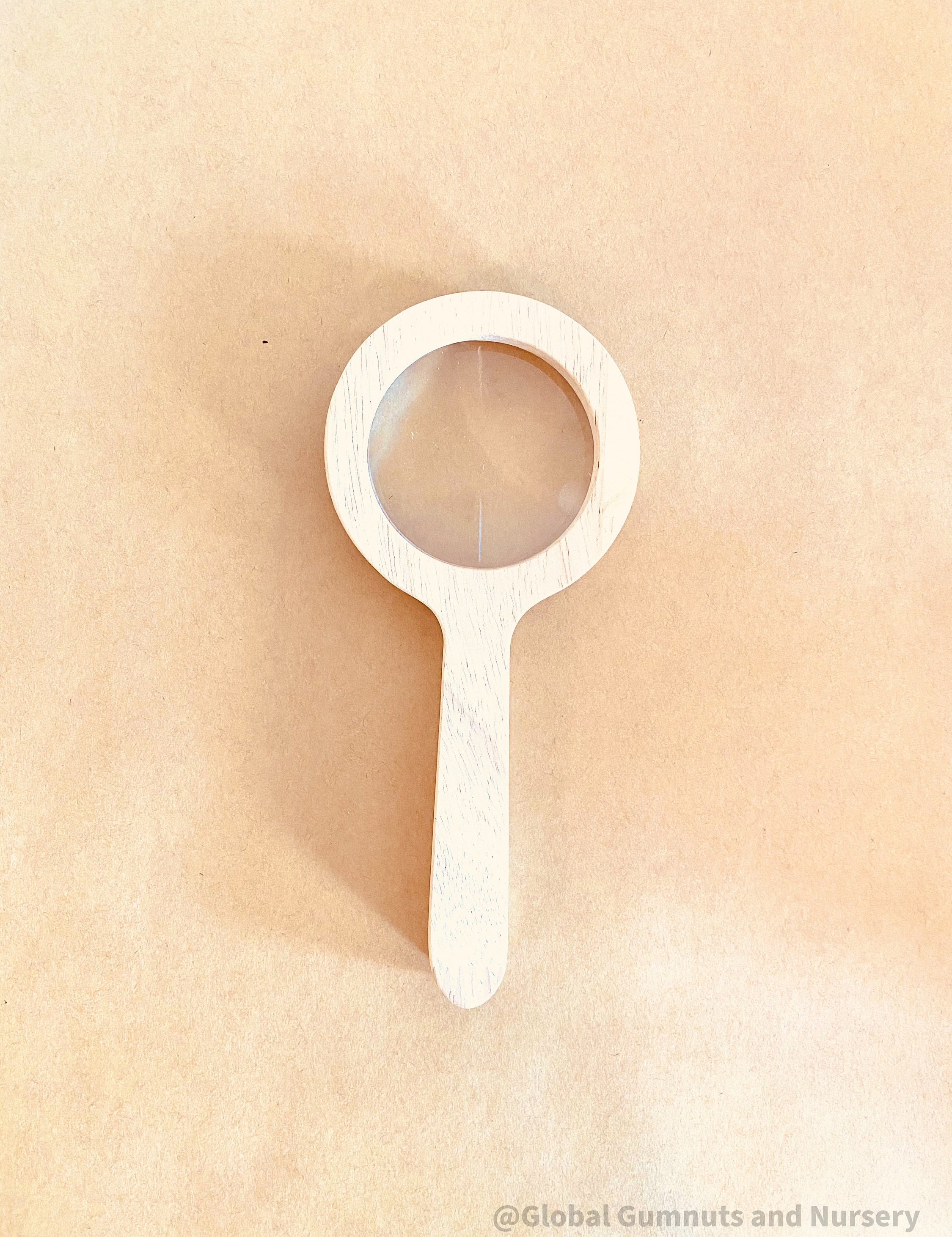 Kids' wooden magnifier, perfect for exploring nature and sparking curiosity in young adventurers.