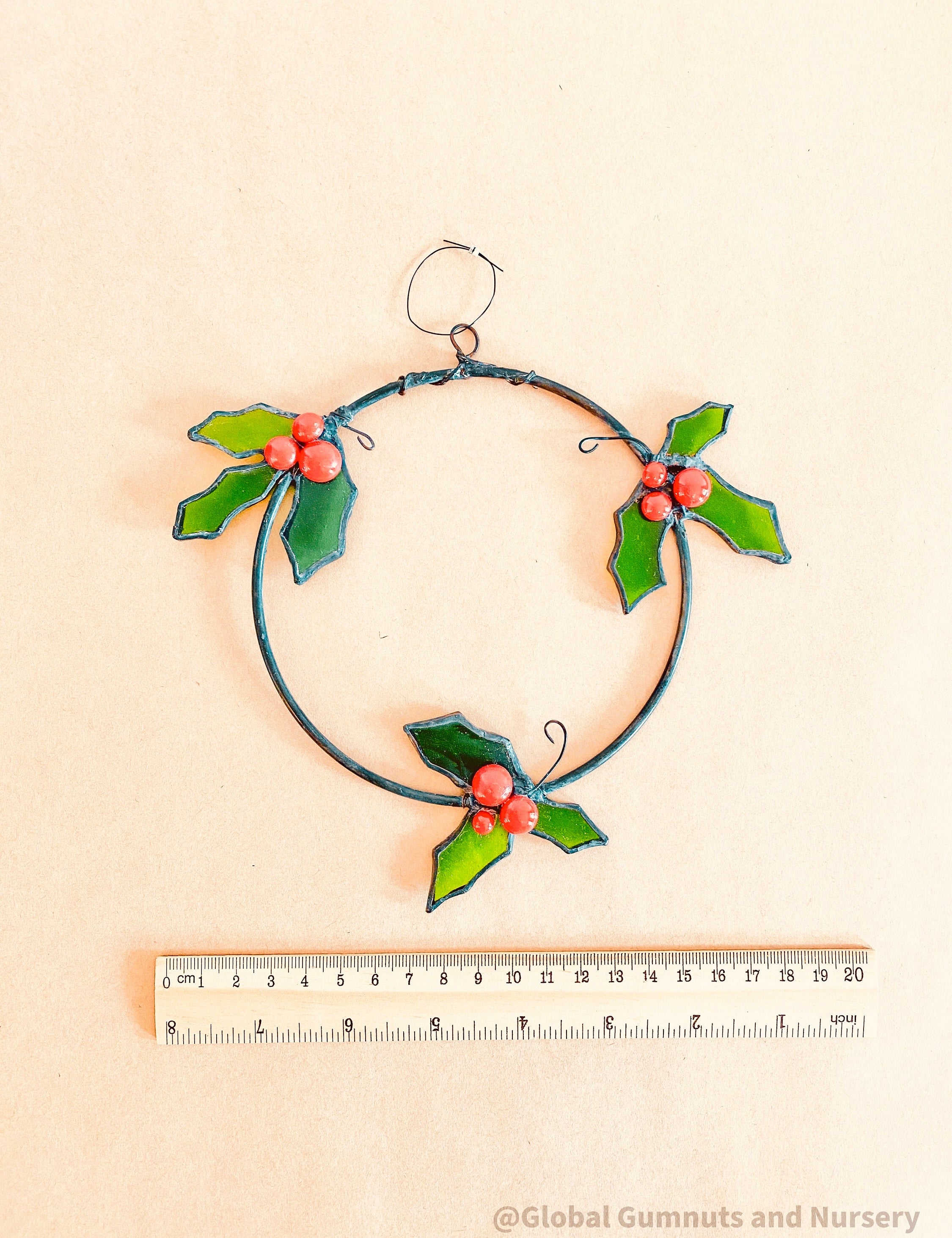 Stained Glass Wreath: Festive wreath with stained glass holly and berries.