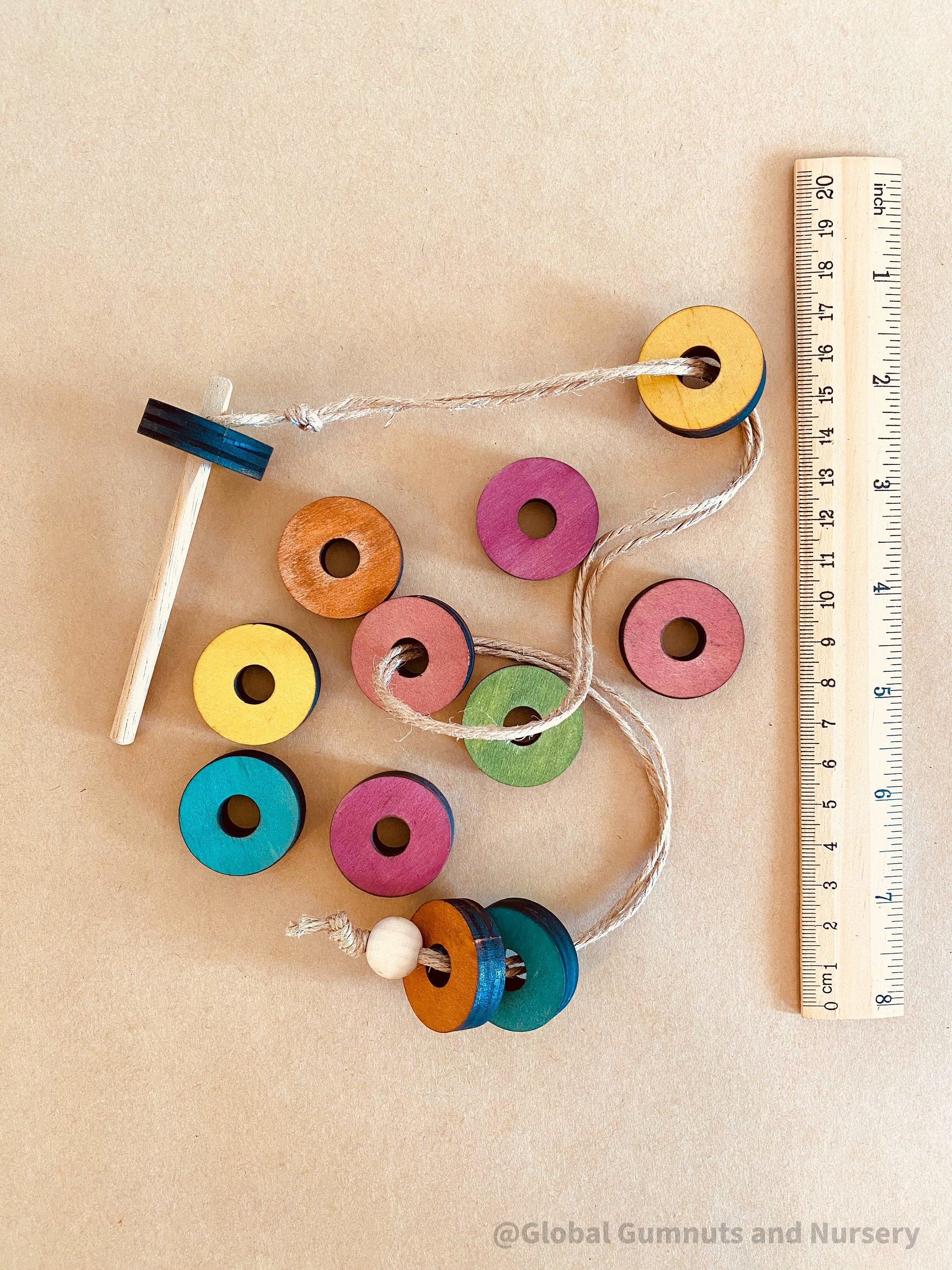 Rainbow Threading Beads: Colourful wooden beads for threading and sensory play, designed to encourage fine motor skills and creativity.