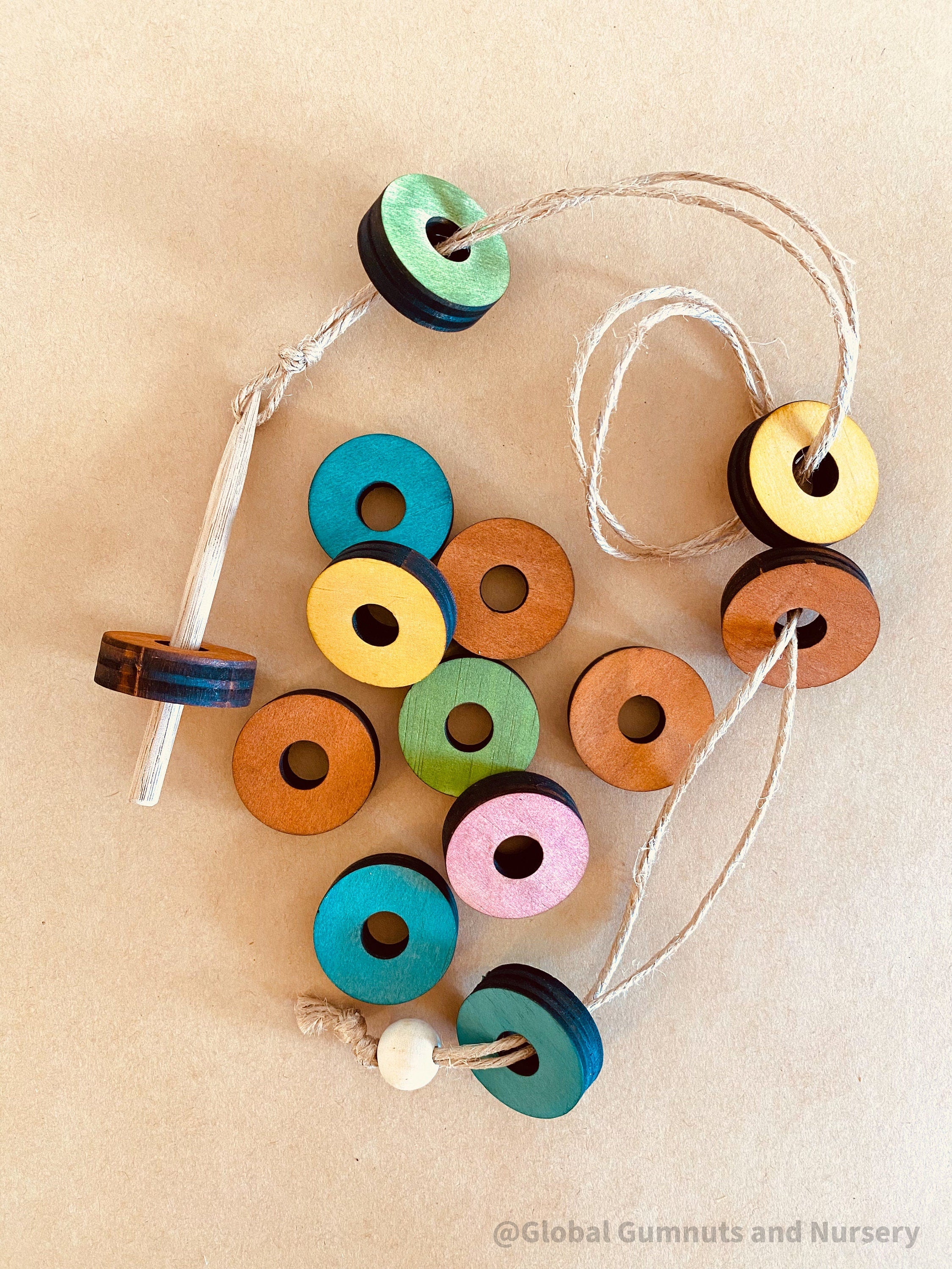 Rainbow Threading Beads: Colourful wooden beads for threading and sensory play, designed to encourage fine motor skills and creativity.