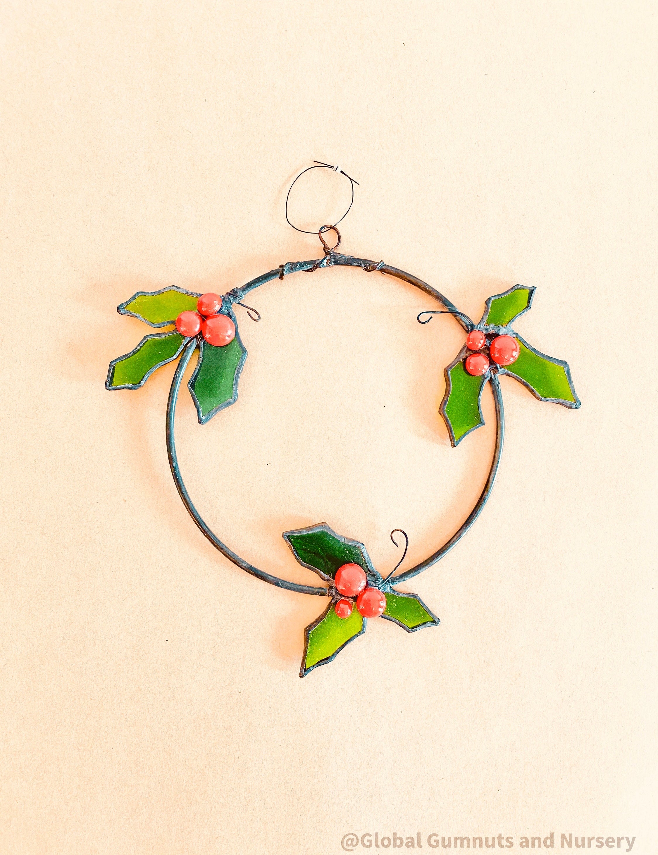 Stained Glass Wreath: Festive wreath with stained glass holly and berries.