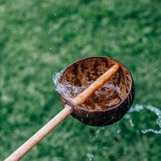 Short handle sand or water scoop, a kid-friendly tool for mud kitchens or play.
