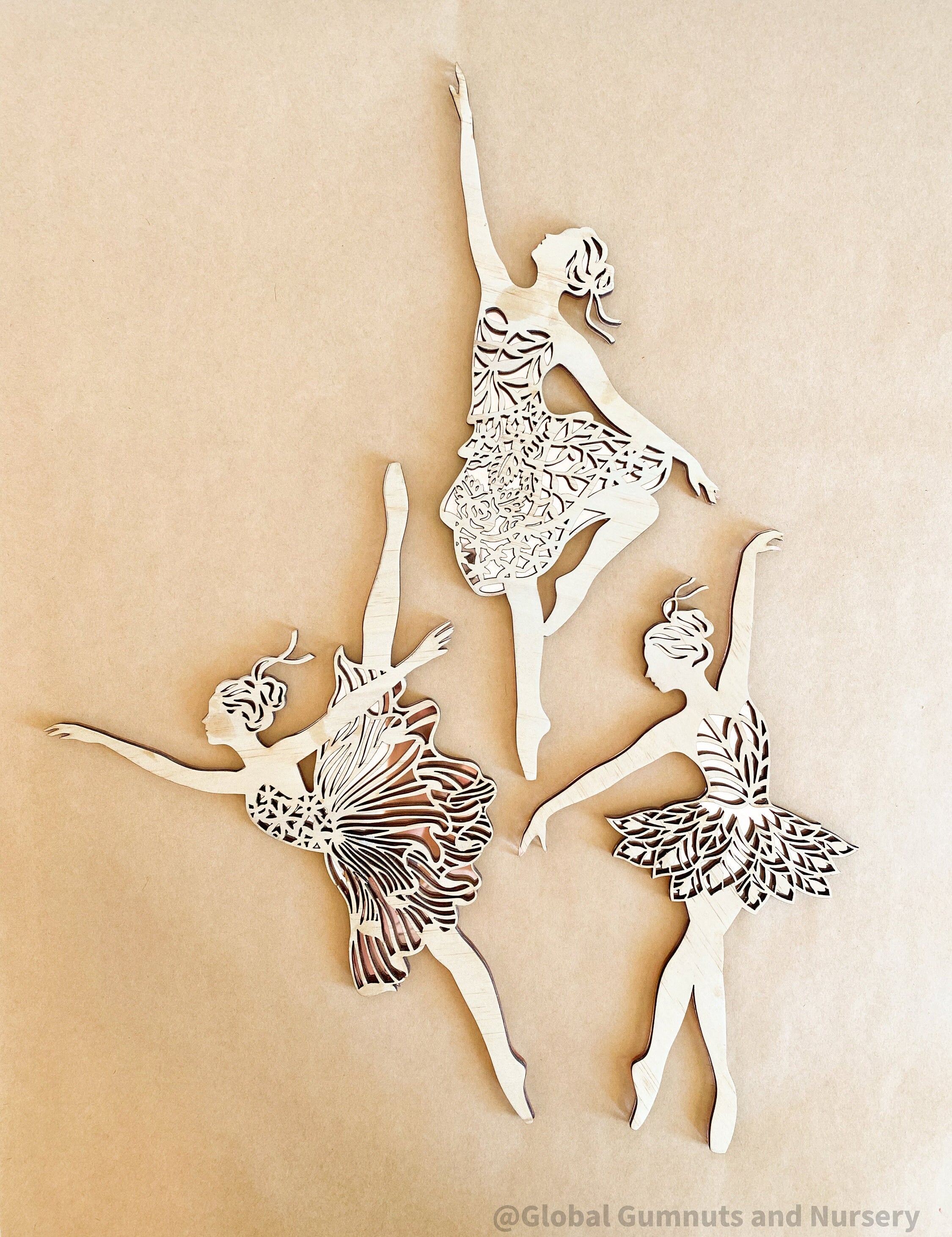 Set of three wooden ballerinas with rose gold backing, elegant wall decor for girls' bedrooms.
