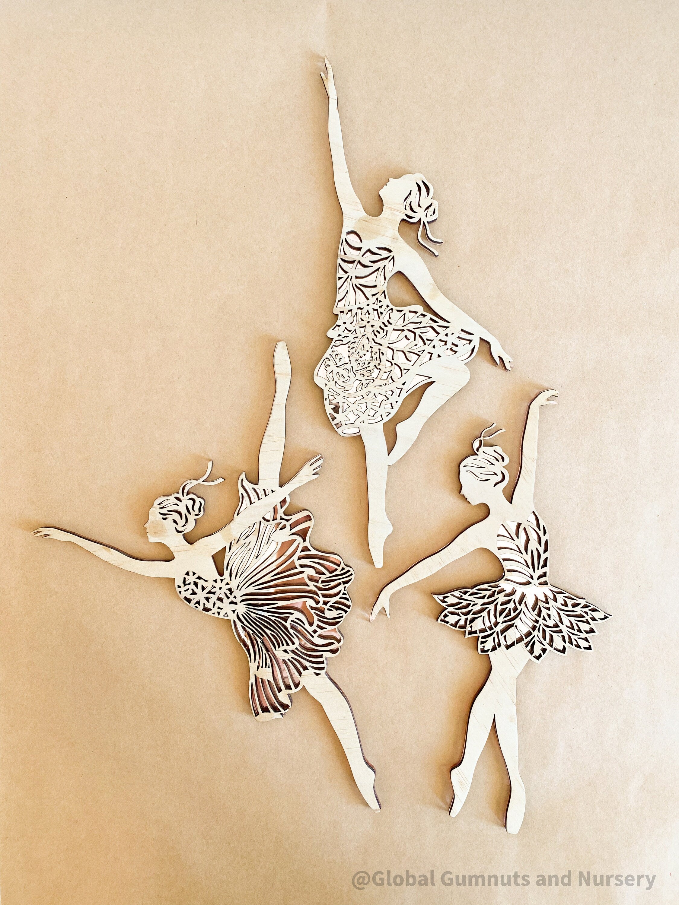 Set of three wooden ballerinas with rose gold backing, elegant wall decor for girls' bedrooms.
