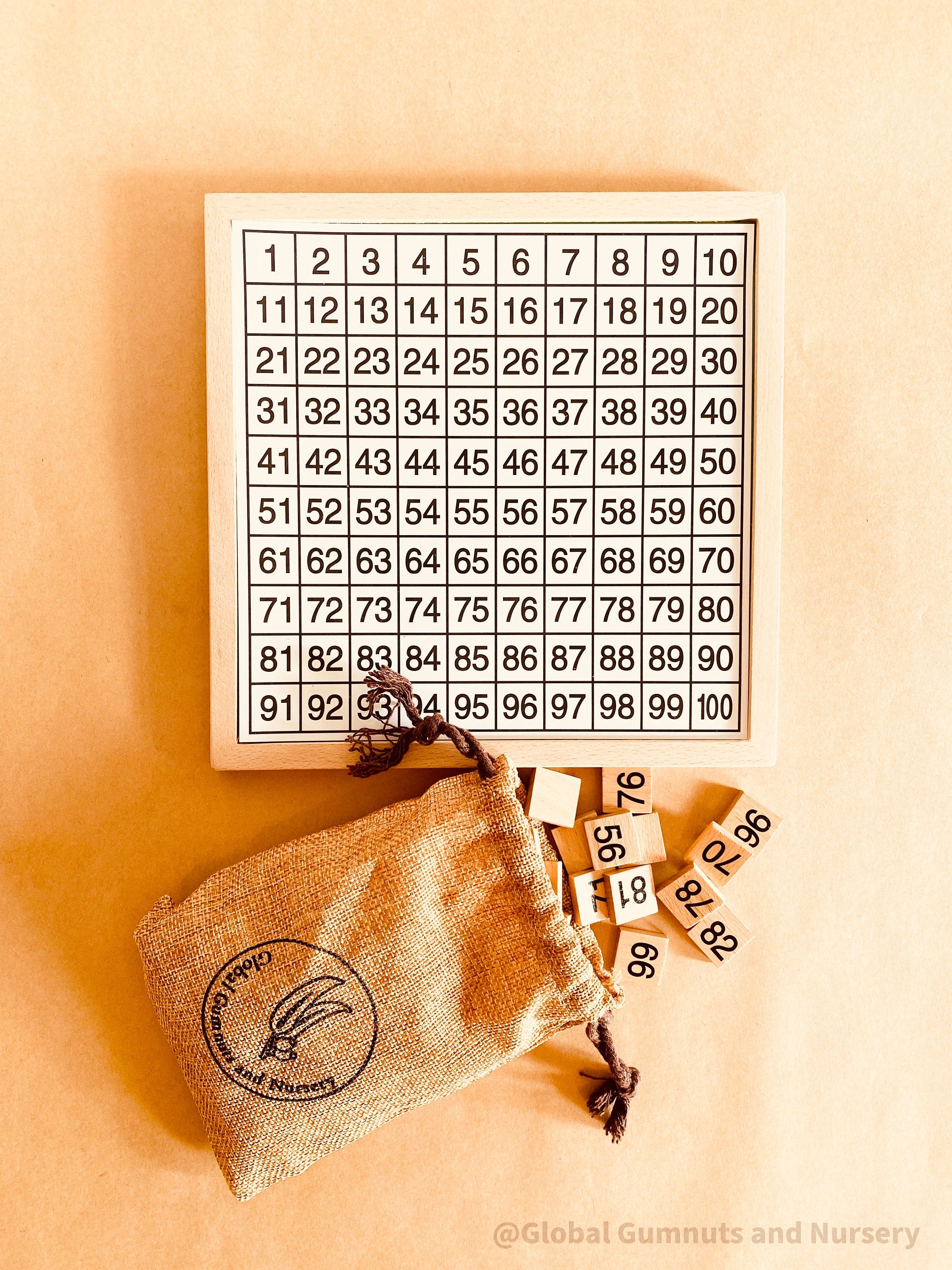 Wooden number board featuring numbers 1-100, perfect for teaching counting, times tables, and number recognition. A fun Montessori-style educational tool for kids.