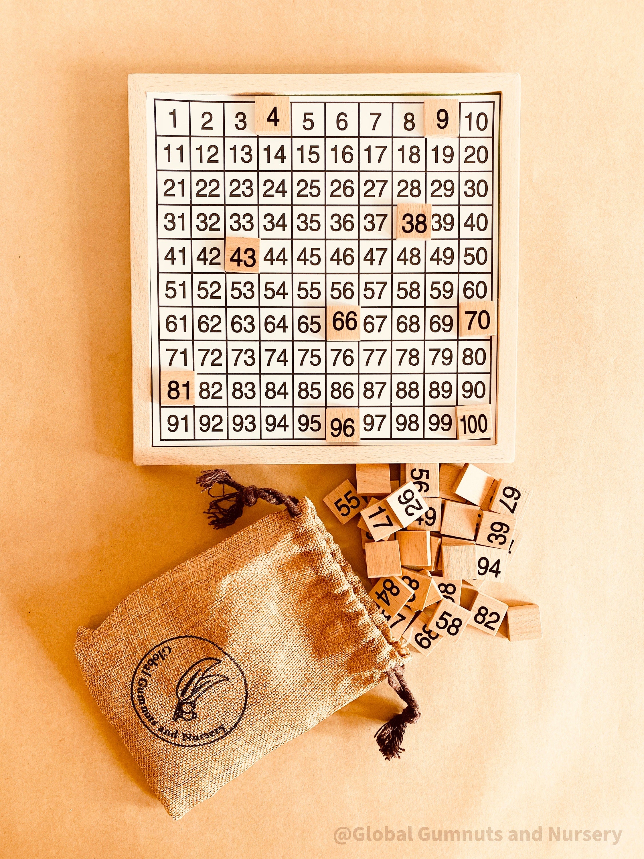 Wooden number board featuring numbers 1-100, perfect for teaching counting, times tables, and number recognition. A fun Montessori-style educational tool for kids.