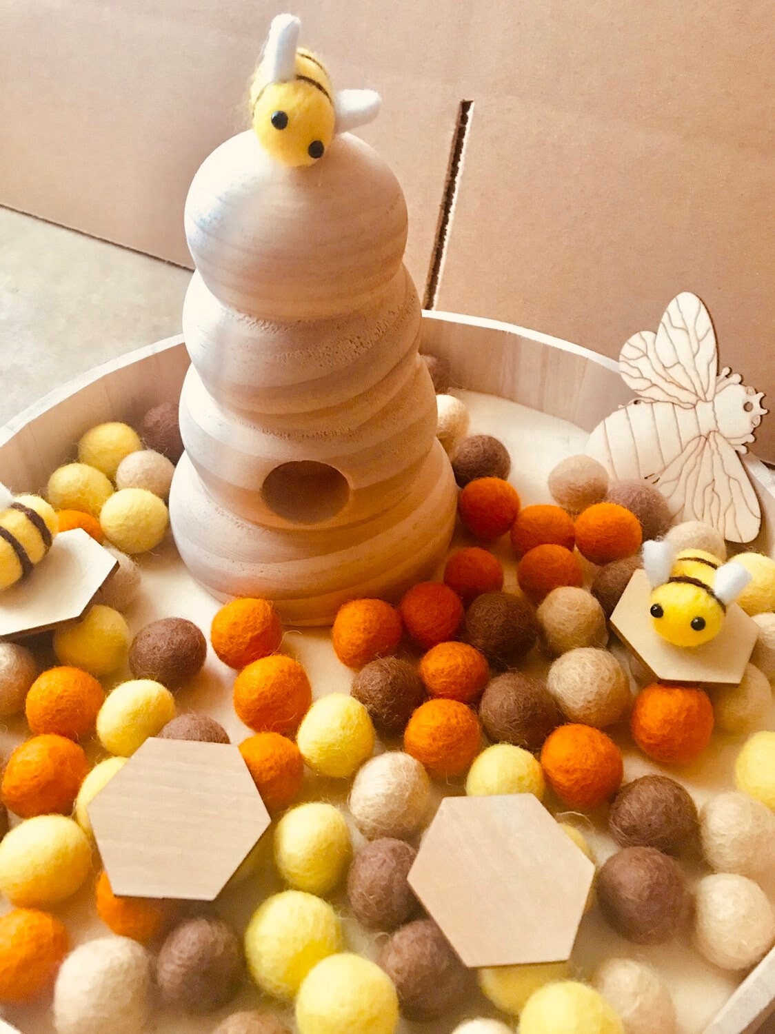 Honey Bee Coloured Felt Balls: Felt balls in bee-inspired colours for creative play and decoration.