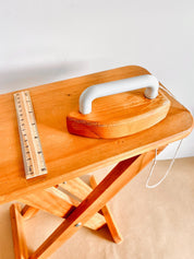 Montessori-inspired vintage pine wood collapsible ironing board and iron set, perfect for role play.