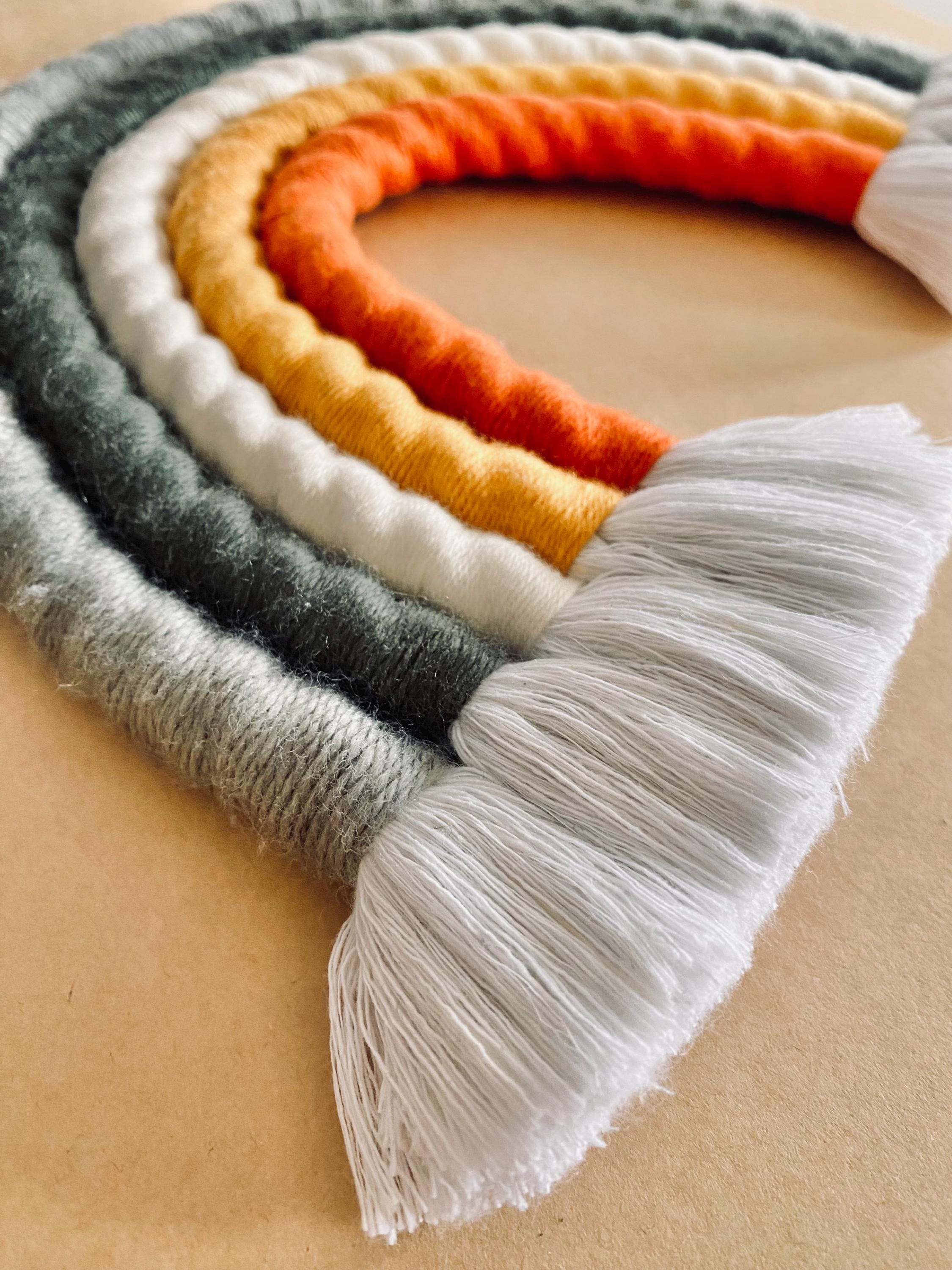 Chunky macrame boho rainbow wall hanging, ideal for brightening up a nursery or adding vibrant decor to any space.