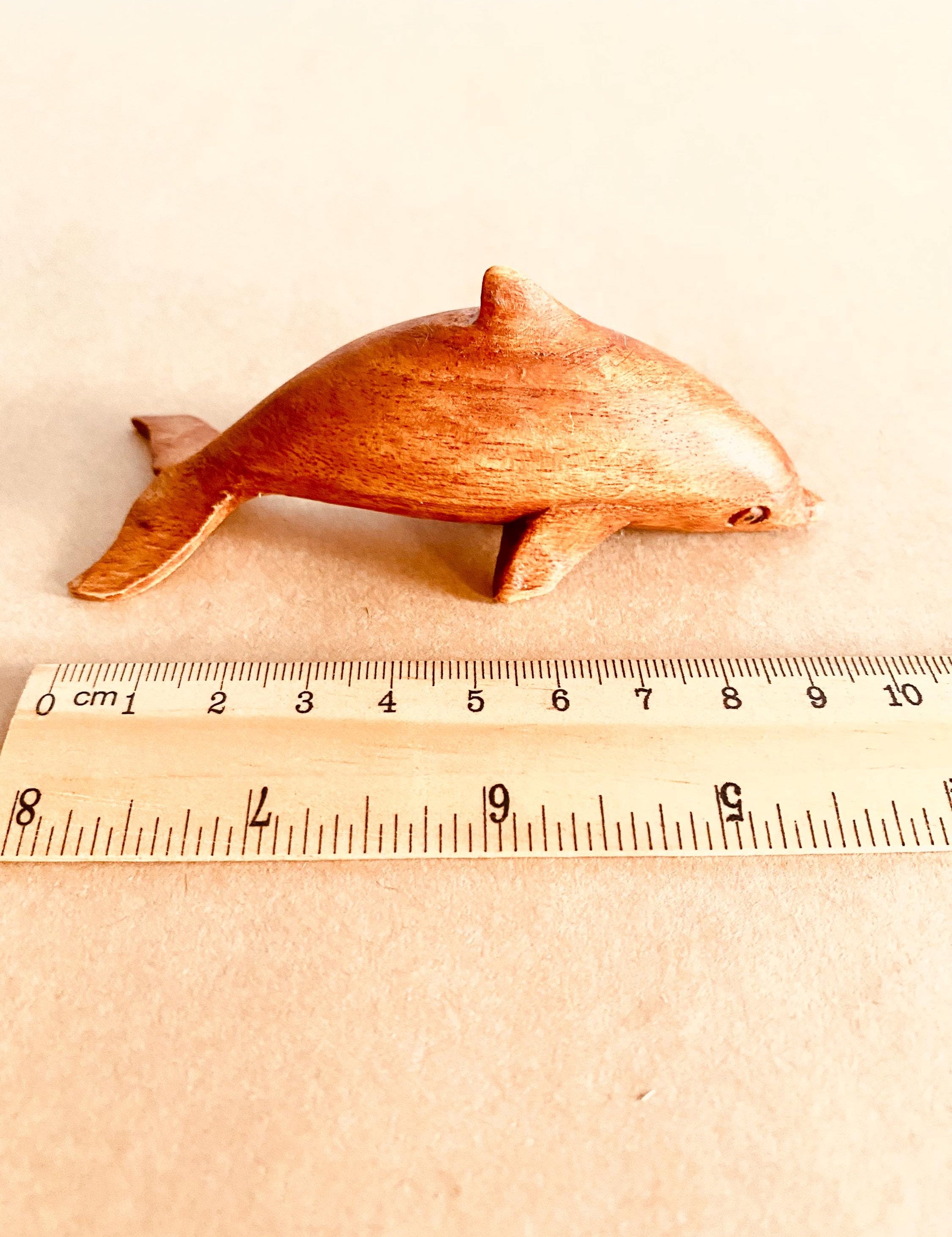 Eco-friendly 11cm wooden dolphin figurine, perfect as sustainable decor or a playful toy.
