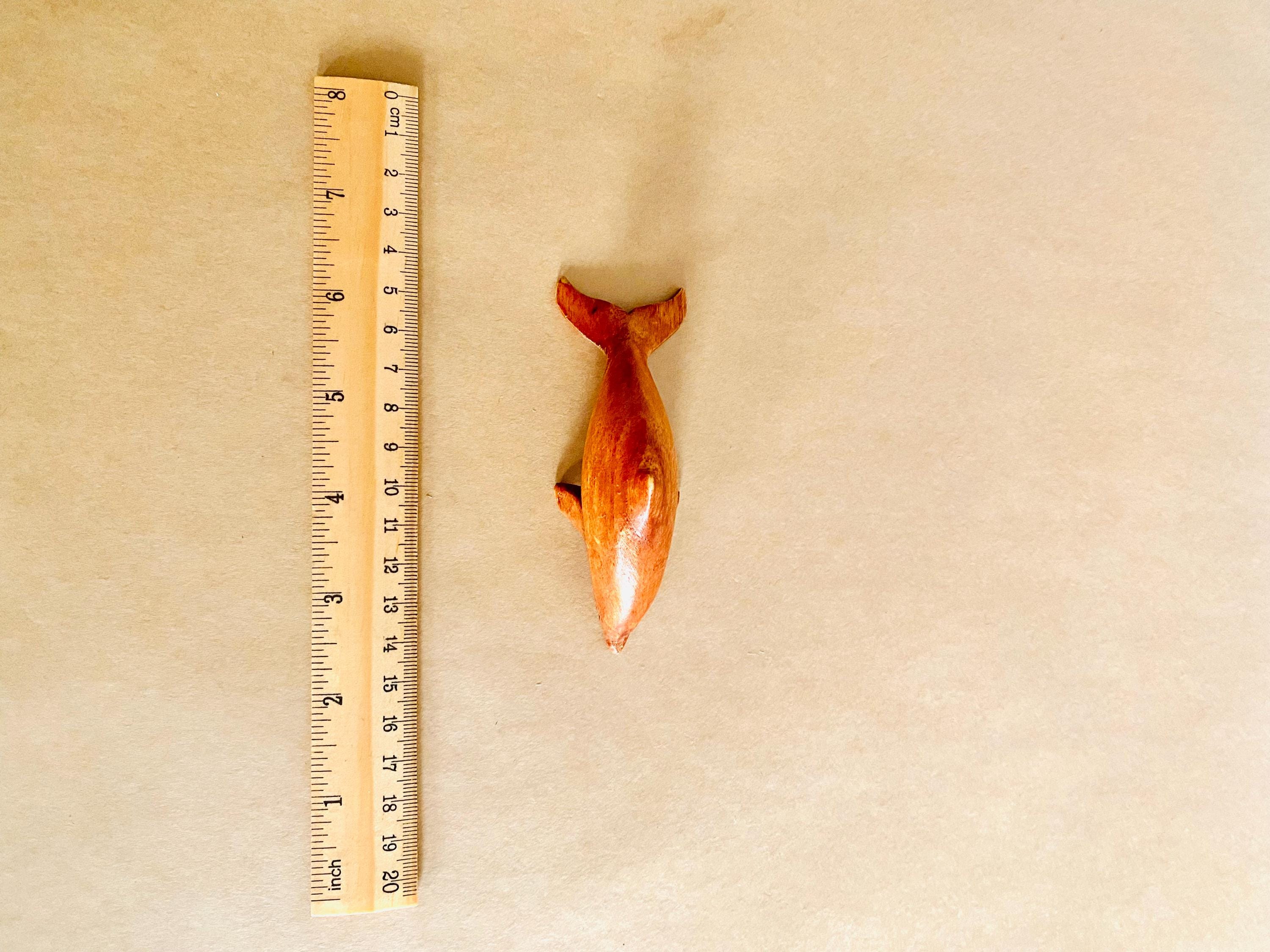 Eco-friendly 11cm wooden dolphin figurine, perfect as sustainable decor or a playful toy.