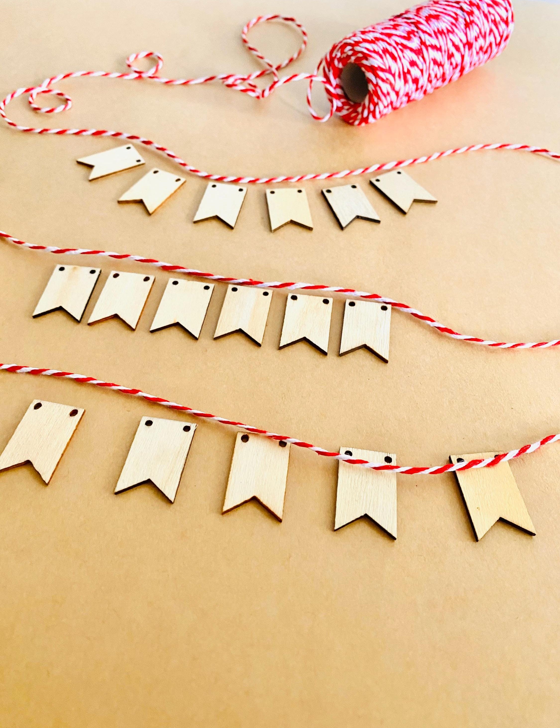 Miniature Wooden Garland with Twine: Small wooden garland with red and white twine for dollhouses or fairy gardens.
