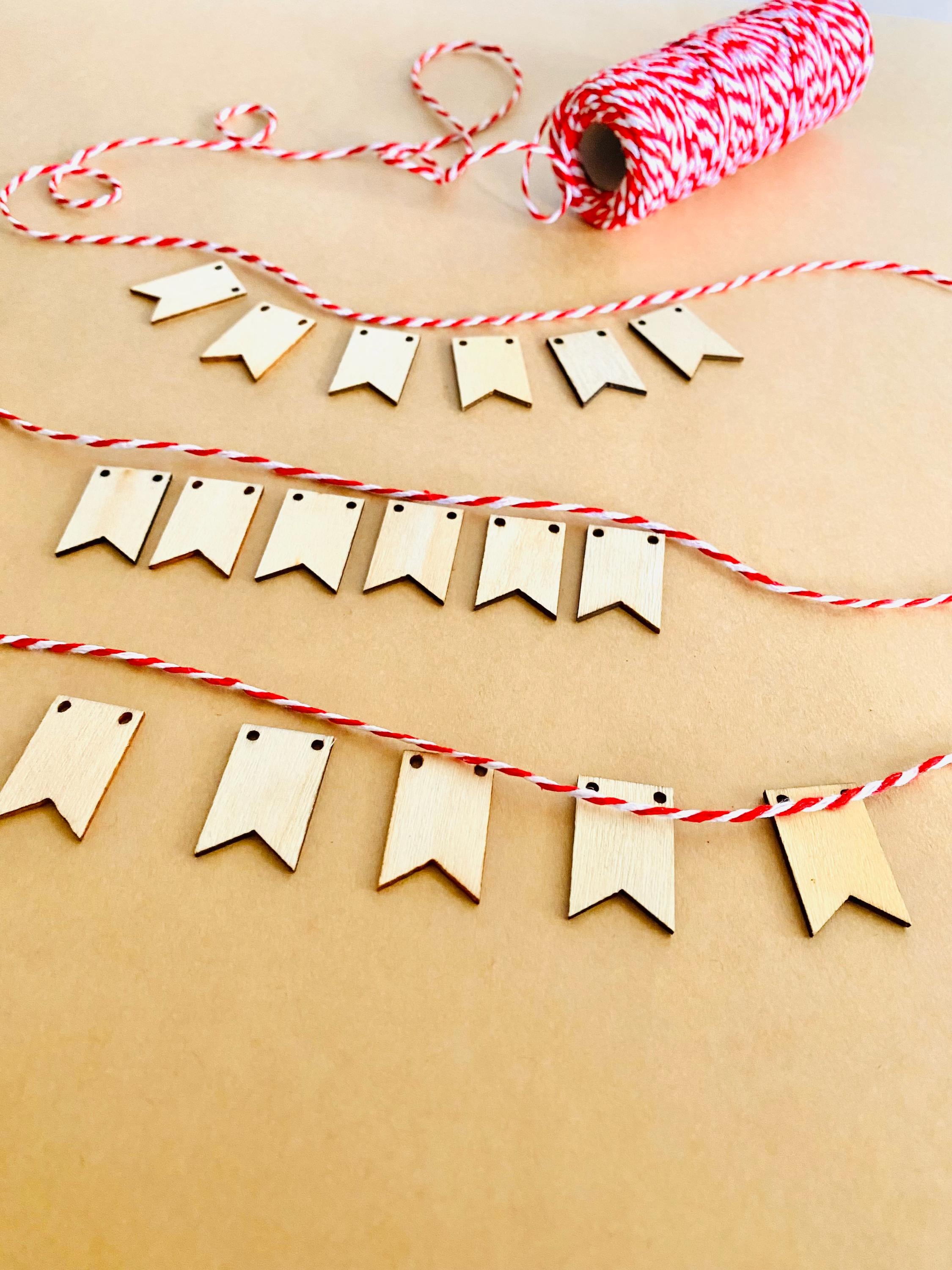 Miniature Wooden Garland with Twine: Small wooden garland with red and white twine for dollhouses or fairy gardens.