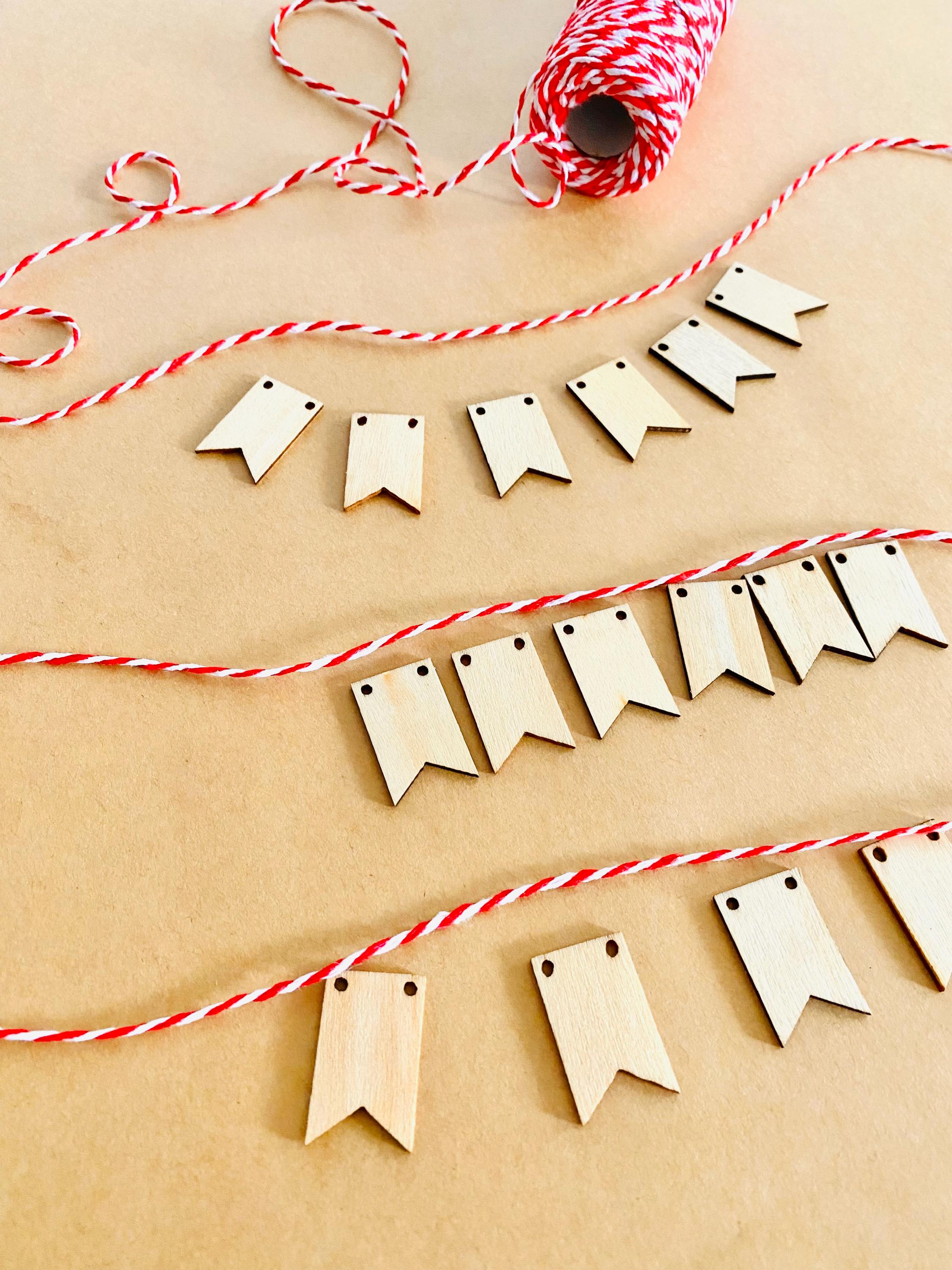 Miniature Wooden Garland with Twine: Small wooden garland with red and white twine for dollhouses or fairy gardens.