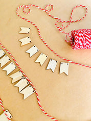 Miniature Wooden Garland with Twine: Small wooden garland with red and white twine for dollhouses or fairy gardens.