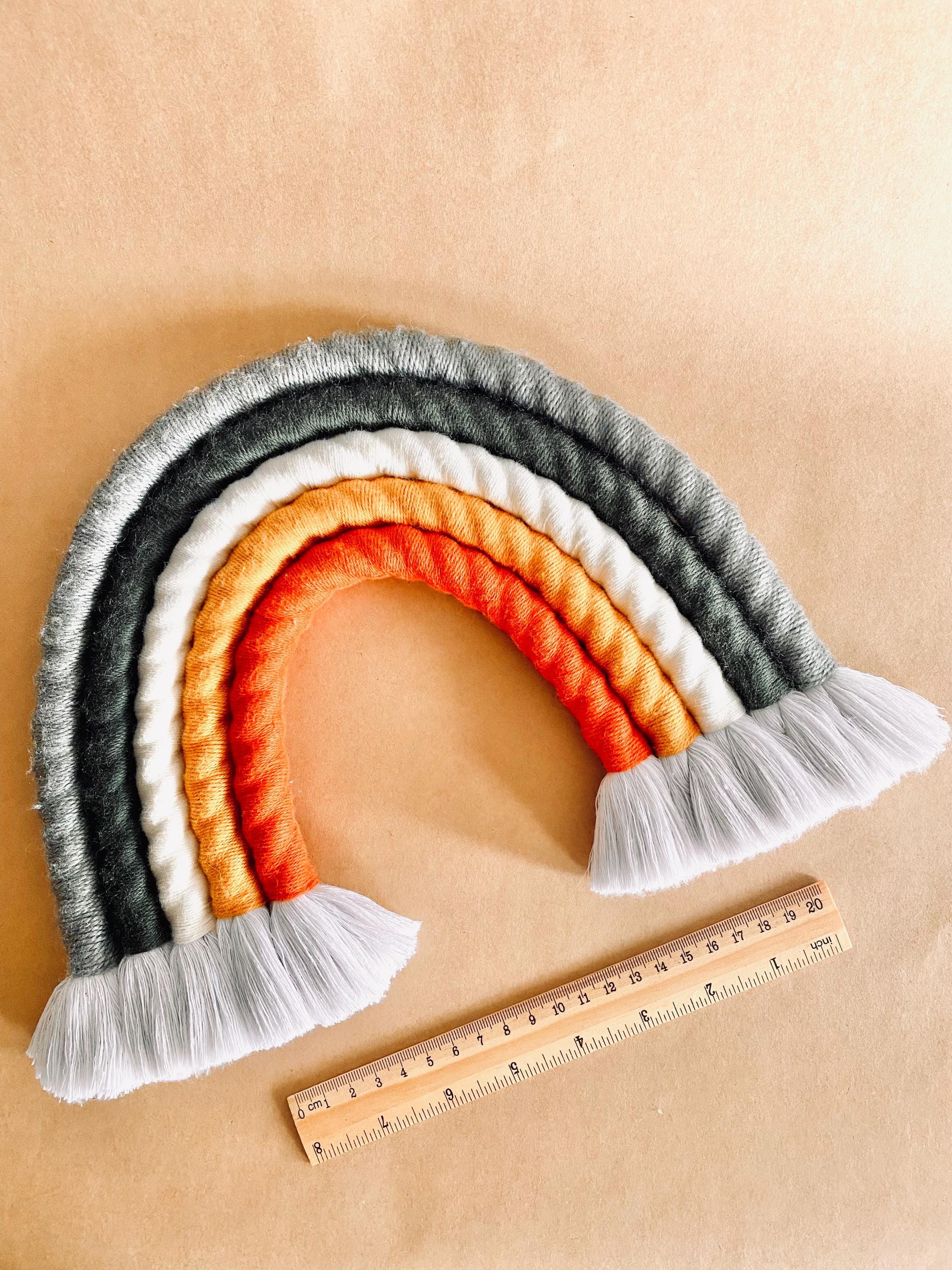 Chunky macrame boho rainbow wall hanging, ideal for brightening up a nursery or adding vibrant decor to any space.