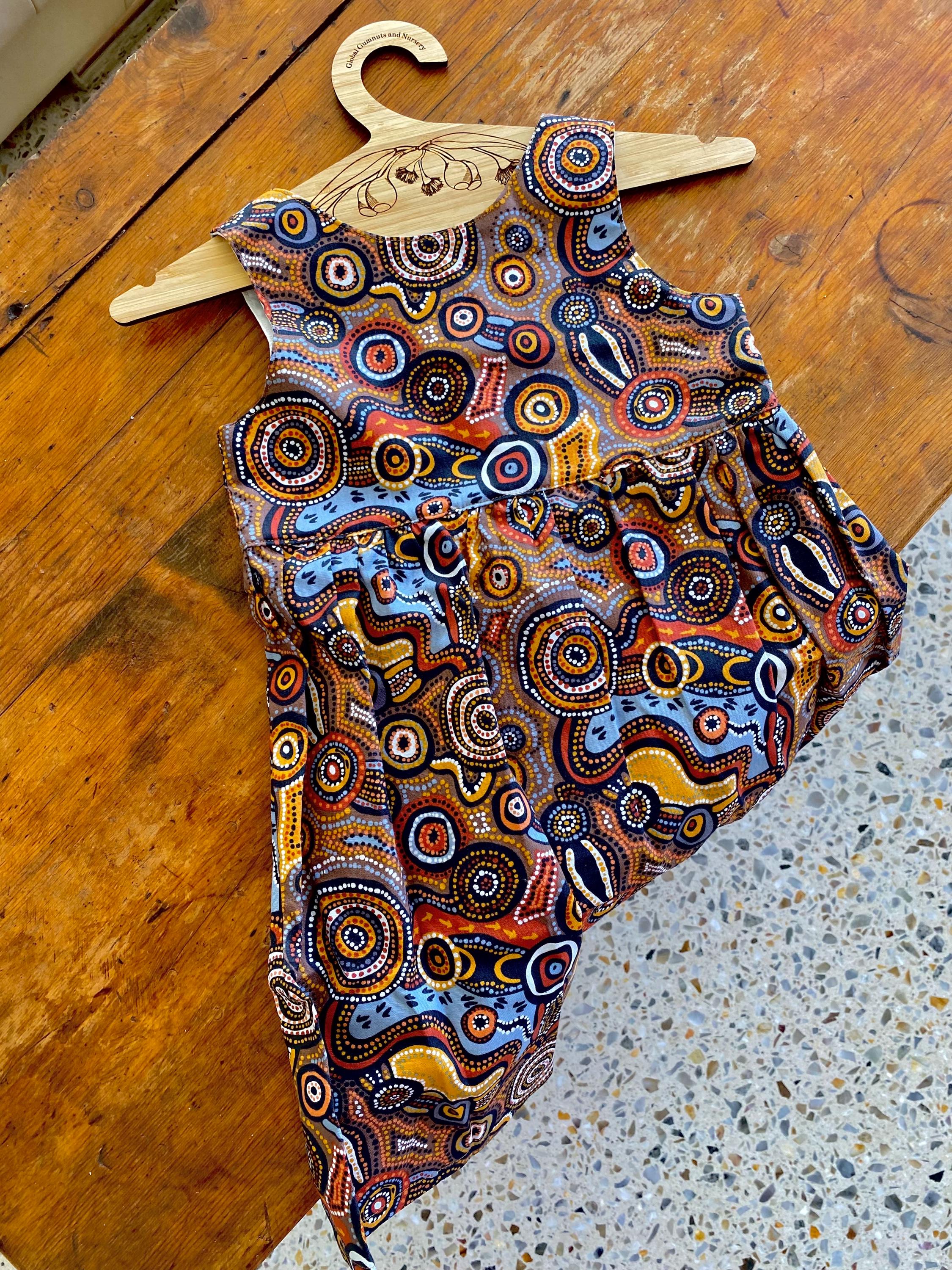 Desert Wind Dress: Girls’ dress made with Indigenous fabric and artistic design.