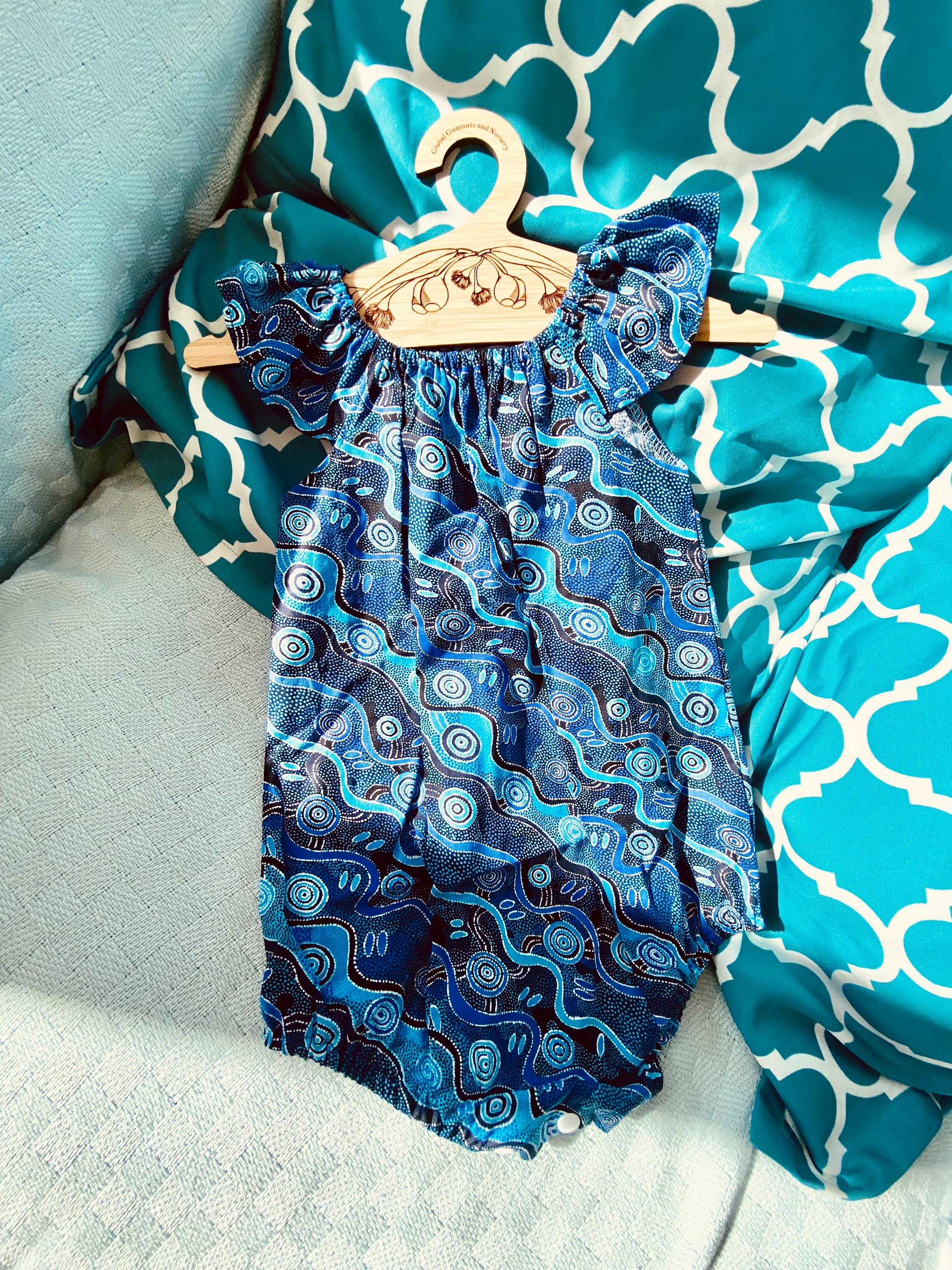 Handmade Desert Tracks Playsuit: Indigenous-inspired cotton playsuit with desert tracks pattern, handmade in Western Australia.