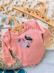 Wooden coat hanger featuring gumnuts and eucalyptus designs, bringing a touch of Australian nature to your closet.