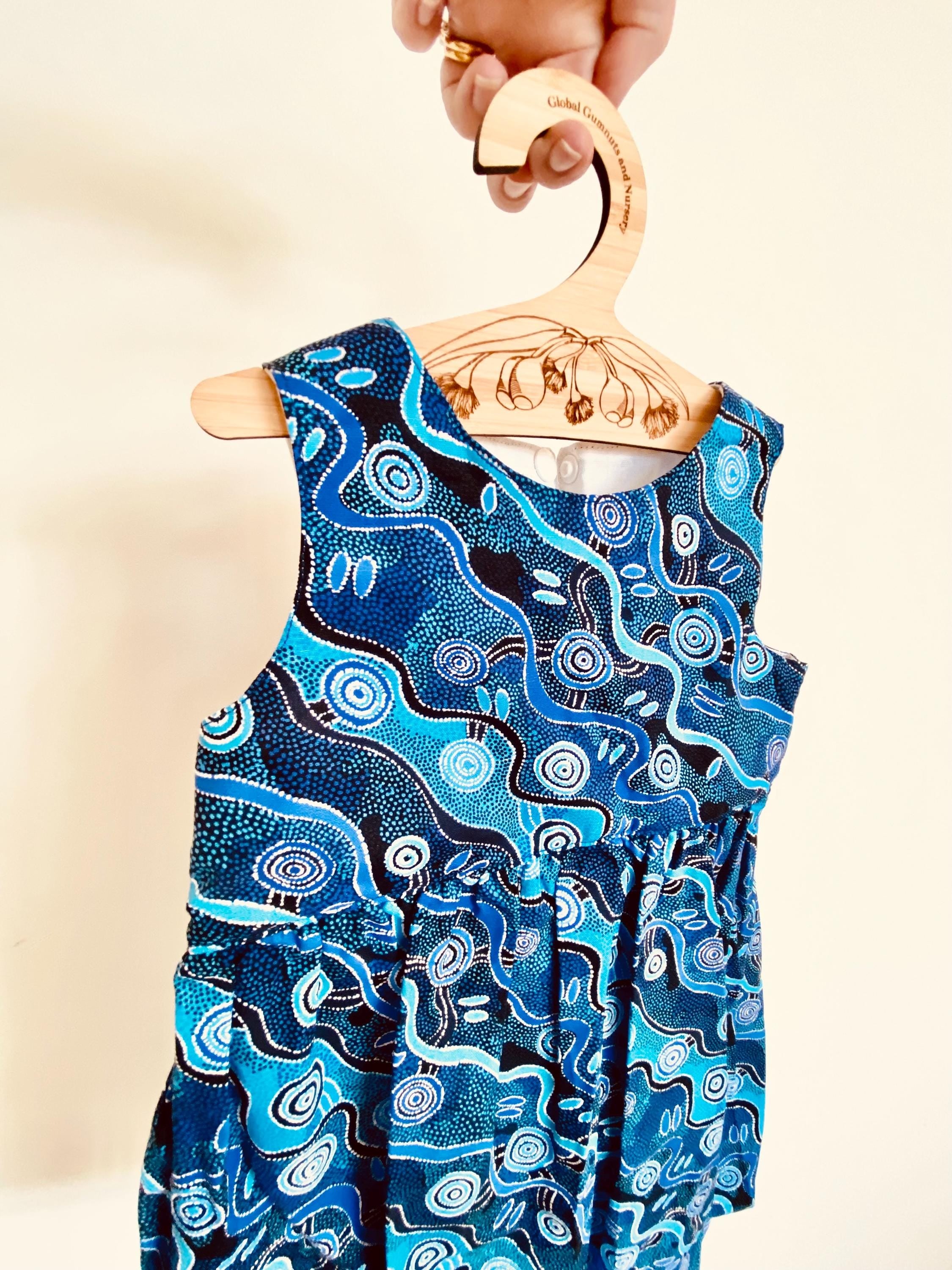Wooden coat hanger featuring gumnuts and eucalyptus designs, bringing a touch of Australian nature to your closet.