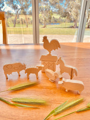 Unpainted birchwood farm animal set, an 8-piece Montessori toy perfect for creative play and crafting.