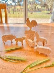 Unpainted birchwood farm animal set, an 8-piece Montessori toy perfect for creative play and crafting.
