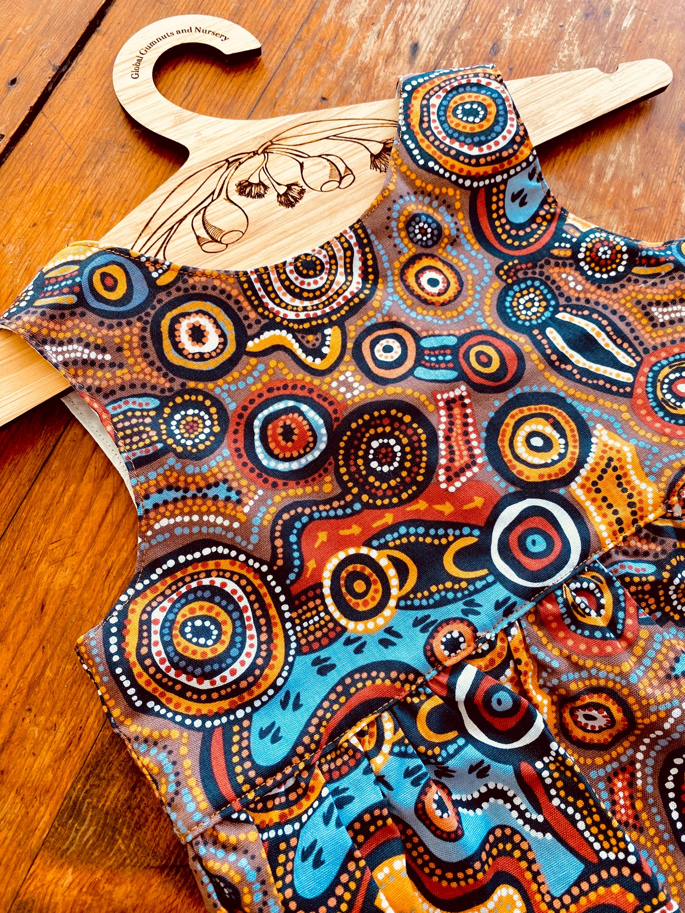 Desert Wind Dress: Girls’ dress made with Indigenous fabric and artistic design.