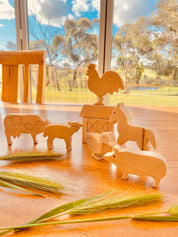 Unpainted birchwood farm animal set, an 8-piece Montessori toy perfect for creative play and crafting.
