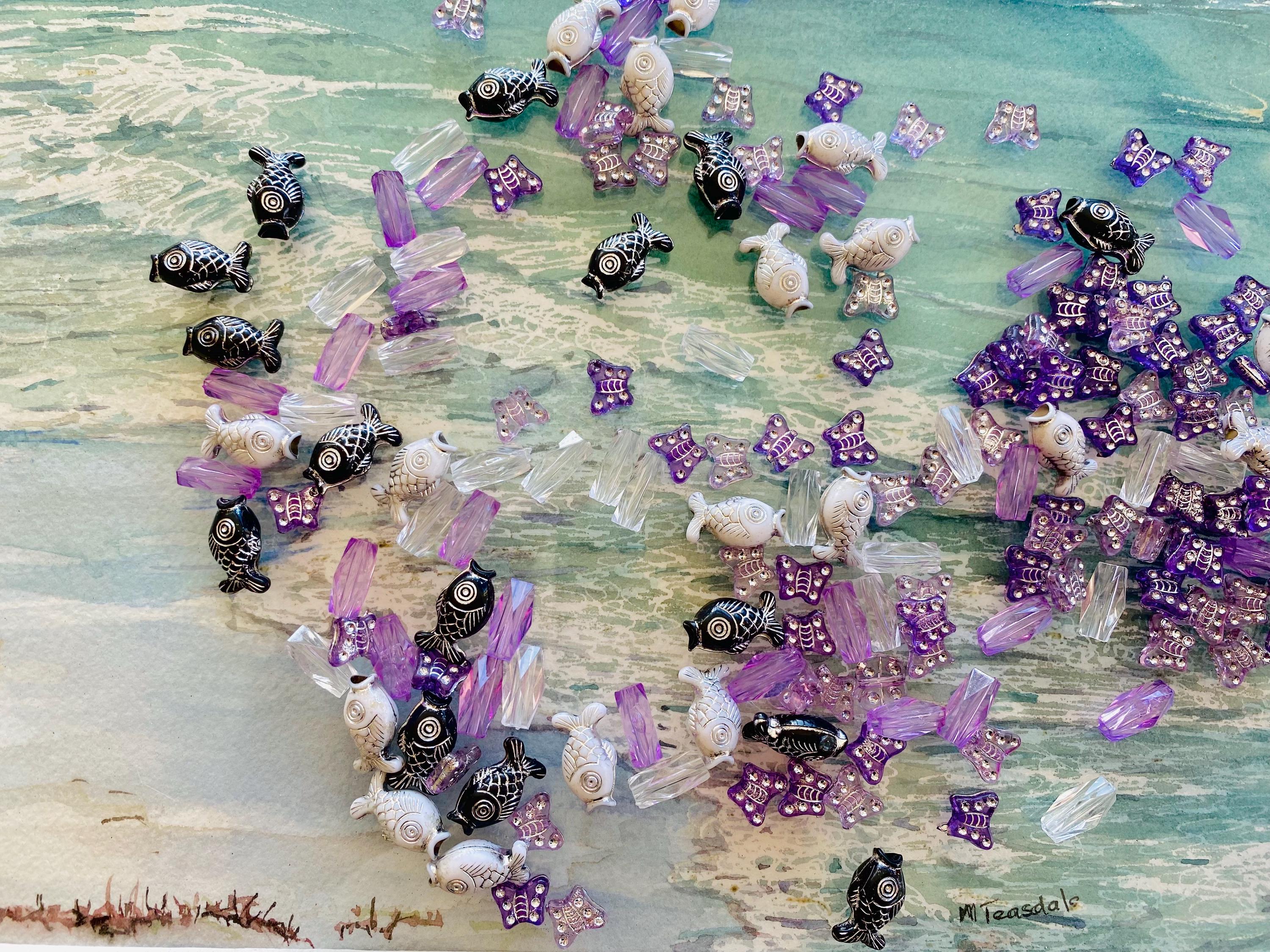 Purple and silver butterfly beads with purple crystals or black, white, and silver fish beads with clear crystals, an elegant ocean bead set.