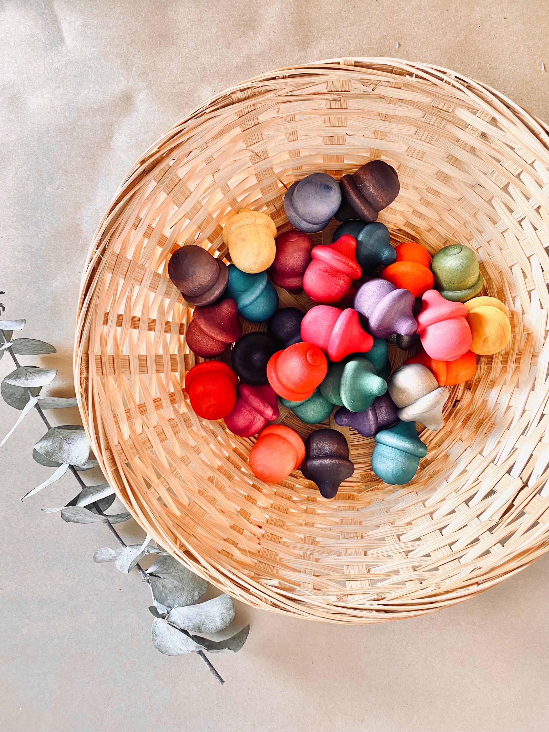 Rainbow wooden acorns, 31 vibrant pieces for play and learning.
