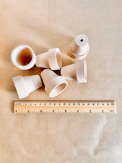Natural mini wooden flower pots, ideal for sensory play, small-world setups, or gardening fun.
