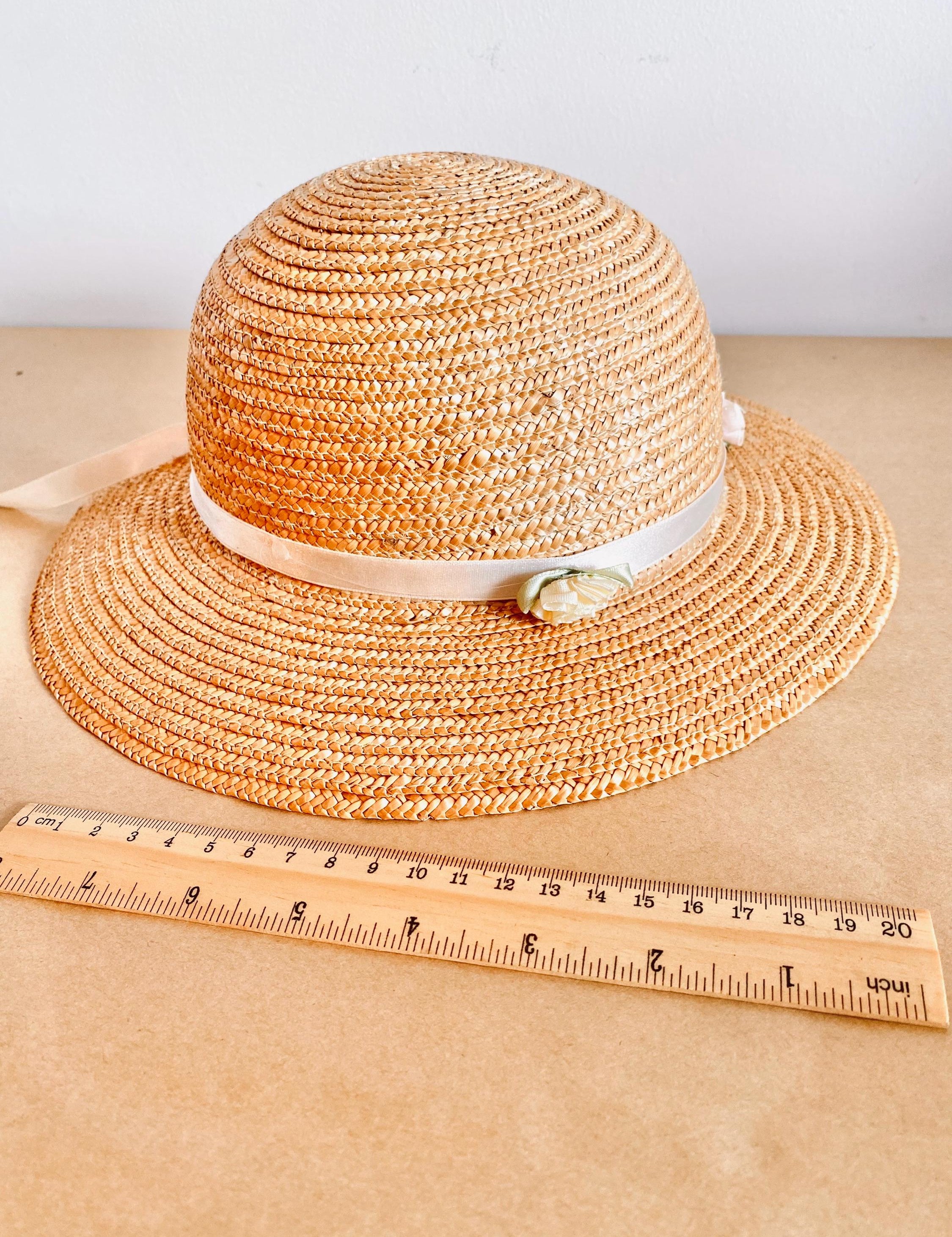 Straw hat with ribbon and floral accents, perfect for crafting, wall decor, or doll dress-up.