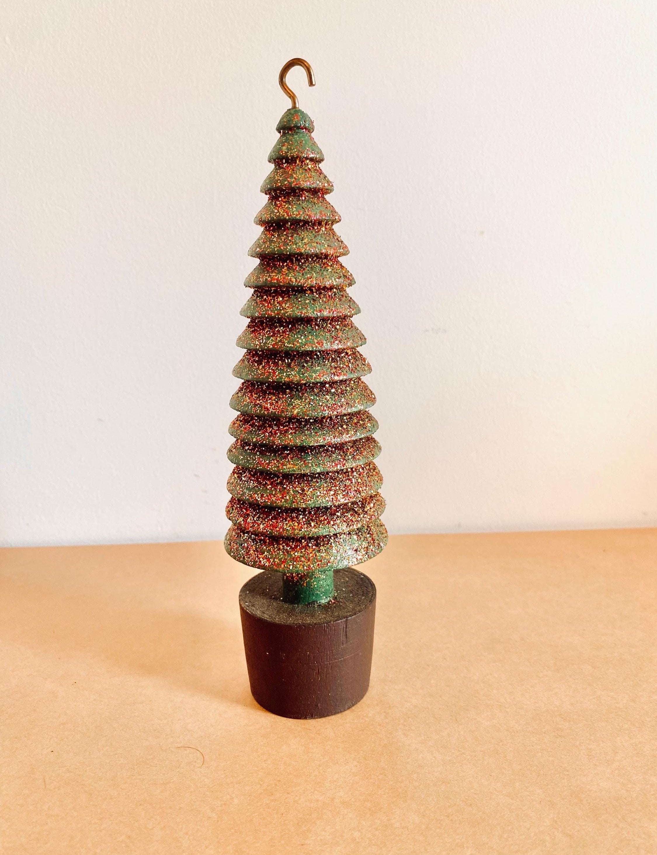 Glittery handmade wooden Christmas trees, creating a magical forest decor for the holiday season.