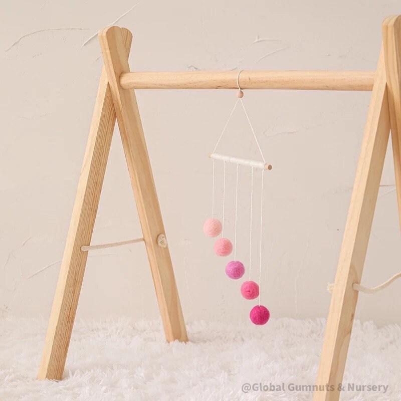Montessori-inspired color bar baby mobile in pink, an eco-friendly and soothing nursery decor.
