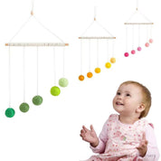 Montessori-inspired color bar baby mobile in pink, an eco-friendly and soothing nursery decor.
