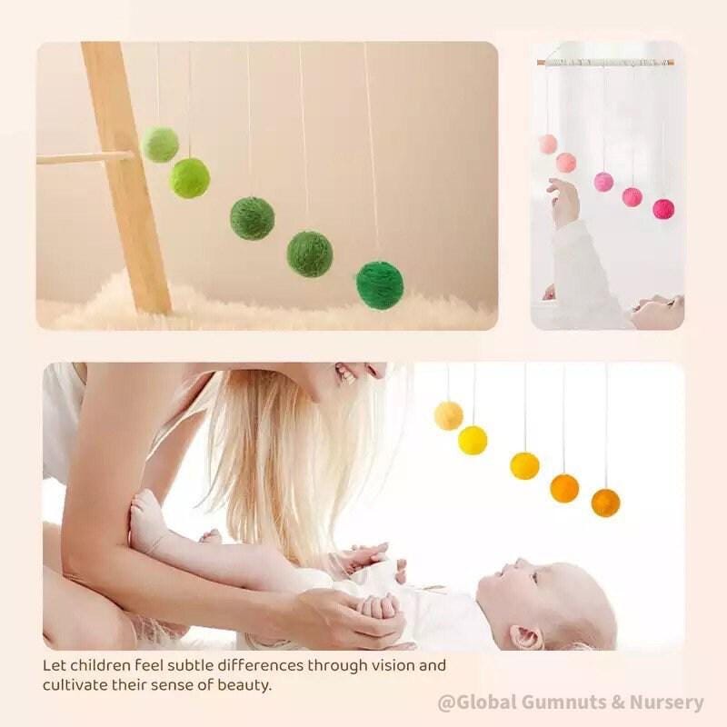 Montessori-inspired color bar baby mobile in pink, an eco-friendly and soothing nursery decor.
