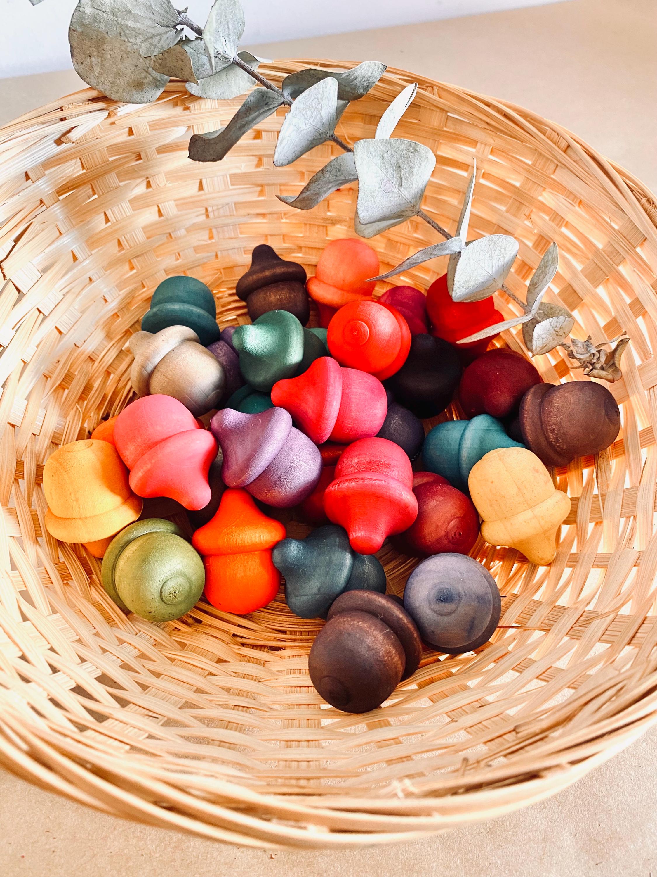 Rainbow wooden acorns, 31 vibrant pieces for play and learning.
