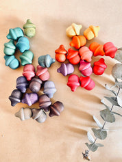 Rainbow wooden acorns, 31 vibrant pieces for play and learning.
